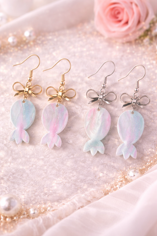 Pastel upside down pineapple and bow drop earrings with gold or silver hardware on marble background