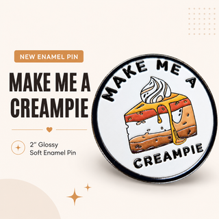 Enamel pin with a piece of cake illustration and text 'Make Me a Creampie' on a white background.