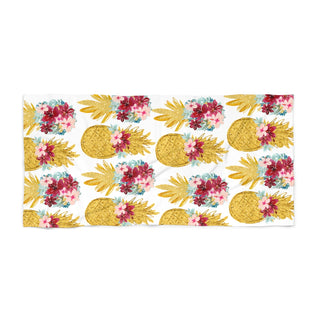 Towel with pineapple and floral pattern on a white background